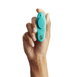 We-Vibe Moxie Plus Wearable Clitoral Vibrator Teal held in a hand for discreet pleasure anywhere.
