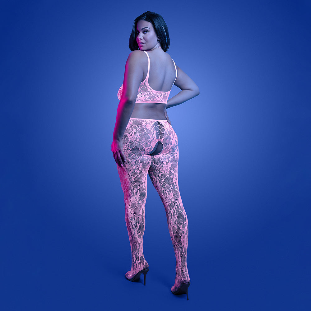 Model wearing Fantasy Lingerie Glow Equilibrium Crotchless Bodystocking with glow-in-the-dark lace, showcasing a bold look.