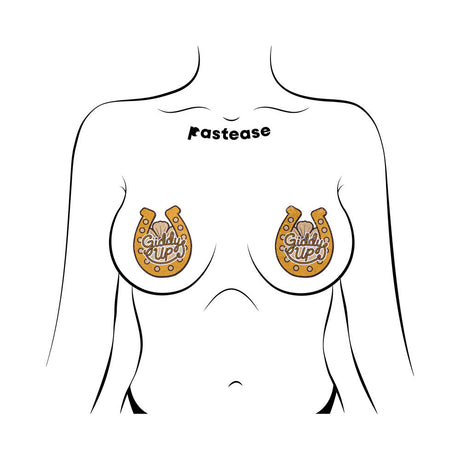 Pastease Giddy Up Sparkling Horseshoe Golden Nipple Covers shown on a model's chest, featuring gold glitter and rope-style lettering.