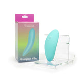 Spectrum Essentials Compact External Vibrator Blue next to its packaging on a display stand.