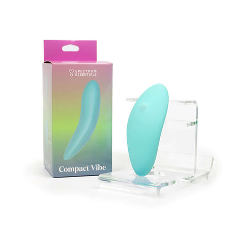 Spectrum Essentials Compact External Vibrator Blue next to its packaging on a display stand.