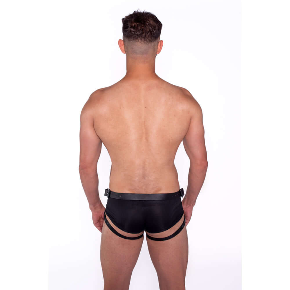 Man wearing Prowler RED Leather Dong Harness Black M from the back in black underwear.