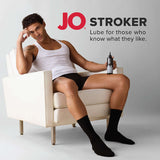 Model sitting with JO Stroker Lubricant 8 Oz, showcasing its use for enhanced pleasure.