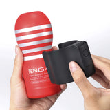 Person holding Tenga Cup Vibrator and vacuum cup, highlighting innovative design for enhanced pleasure.