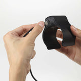 Person connecting a charging cable to the Tenga Cup Vibrator for convenient recharging.