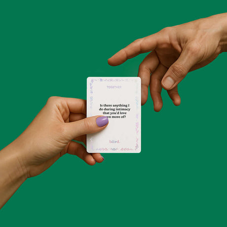 Biird x Jouissance Club Together Couples Card Game hand holding activity card with green background.