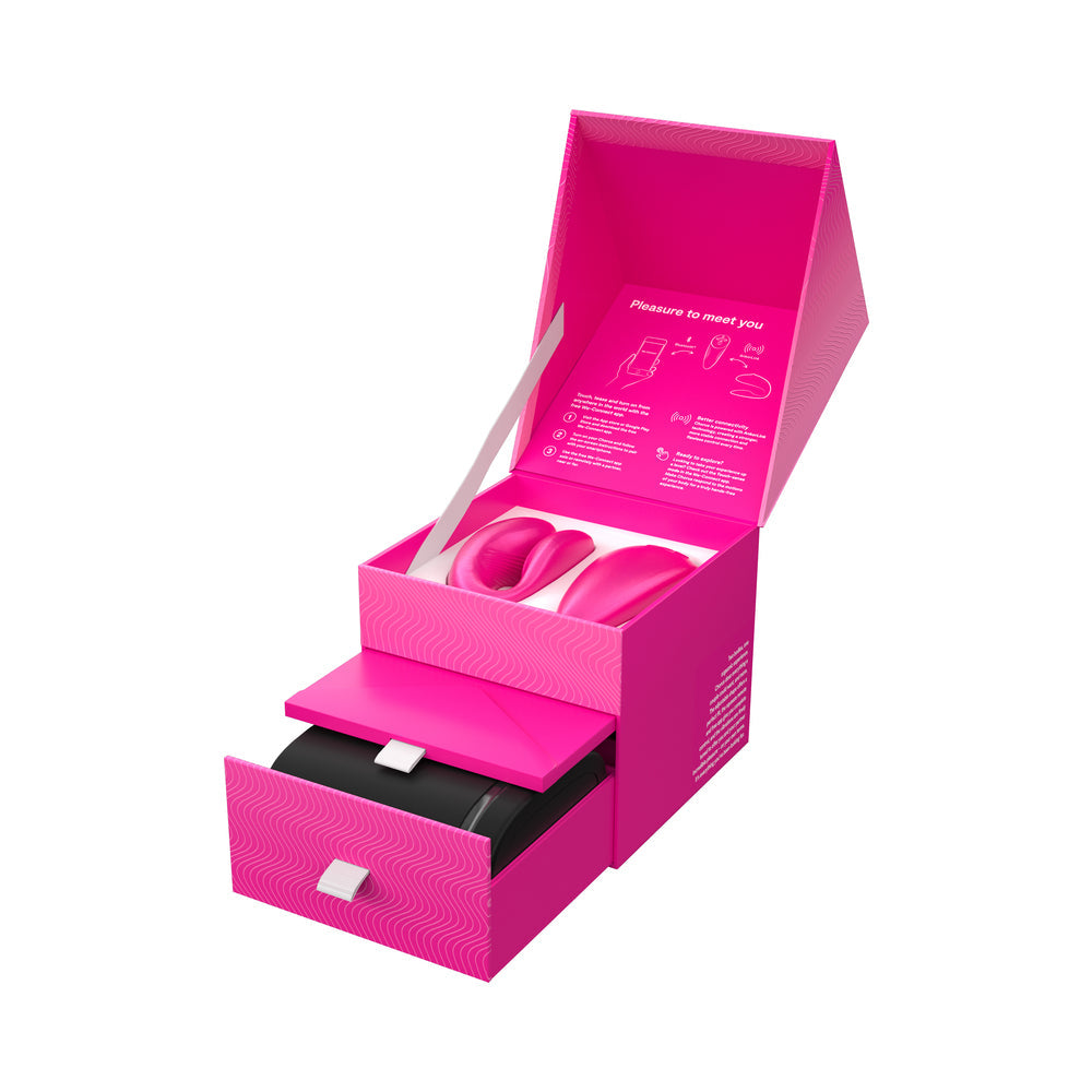 We-Vibe Chorus Couples Vibrator Cosmic Pink packaging open with products inside, showcasing a vibrant pink design.