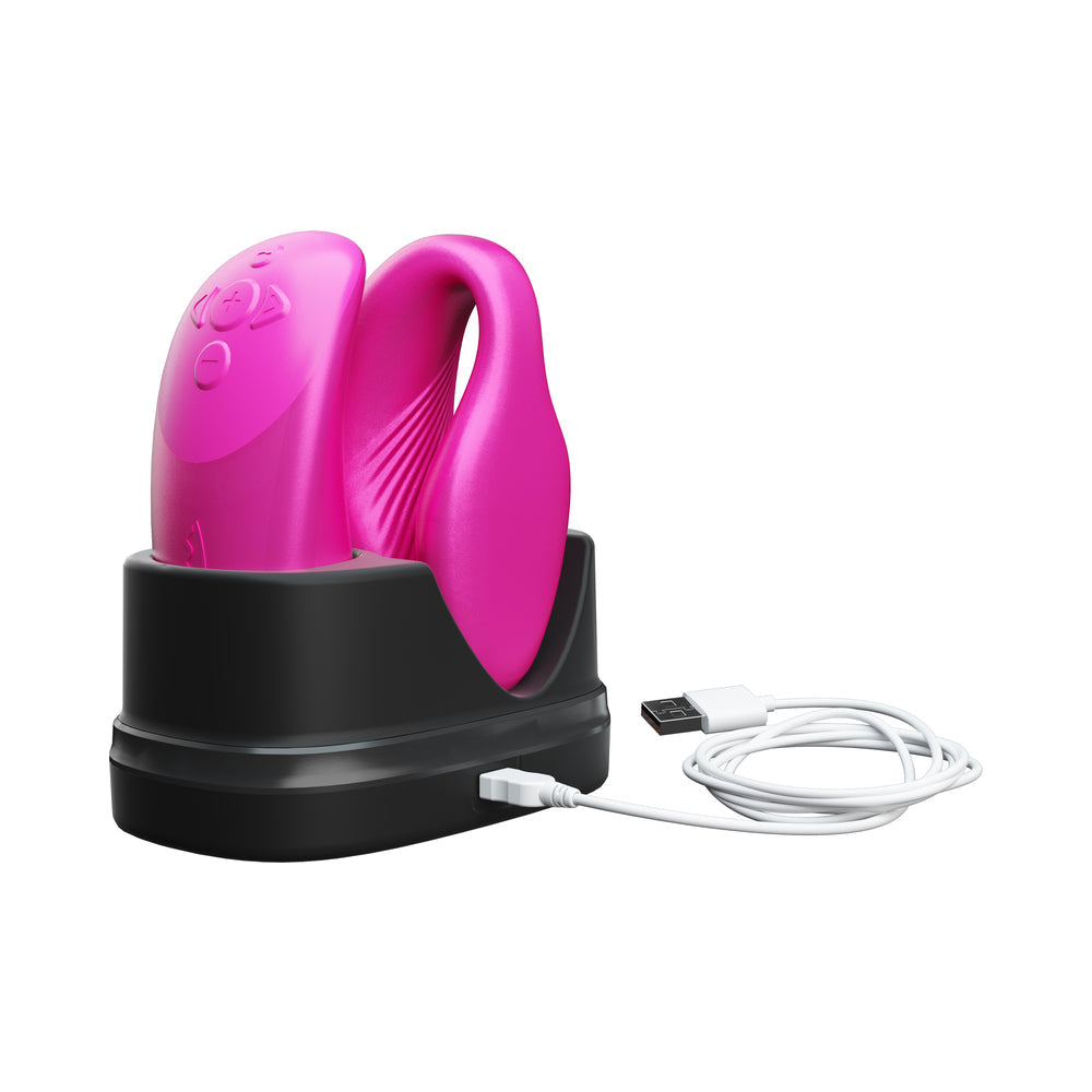 We-Vibe Chorus Couples Vibrator Cosmic Pink charging in its dock with USB connection.