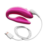 We-Vibe Chorus Couples Vibrator Cosmic Pink with USB charging cable, designed for shared intimacy and customizable pleasure.