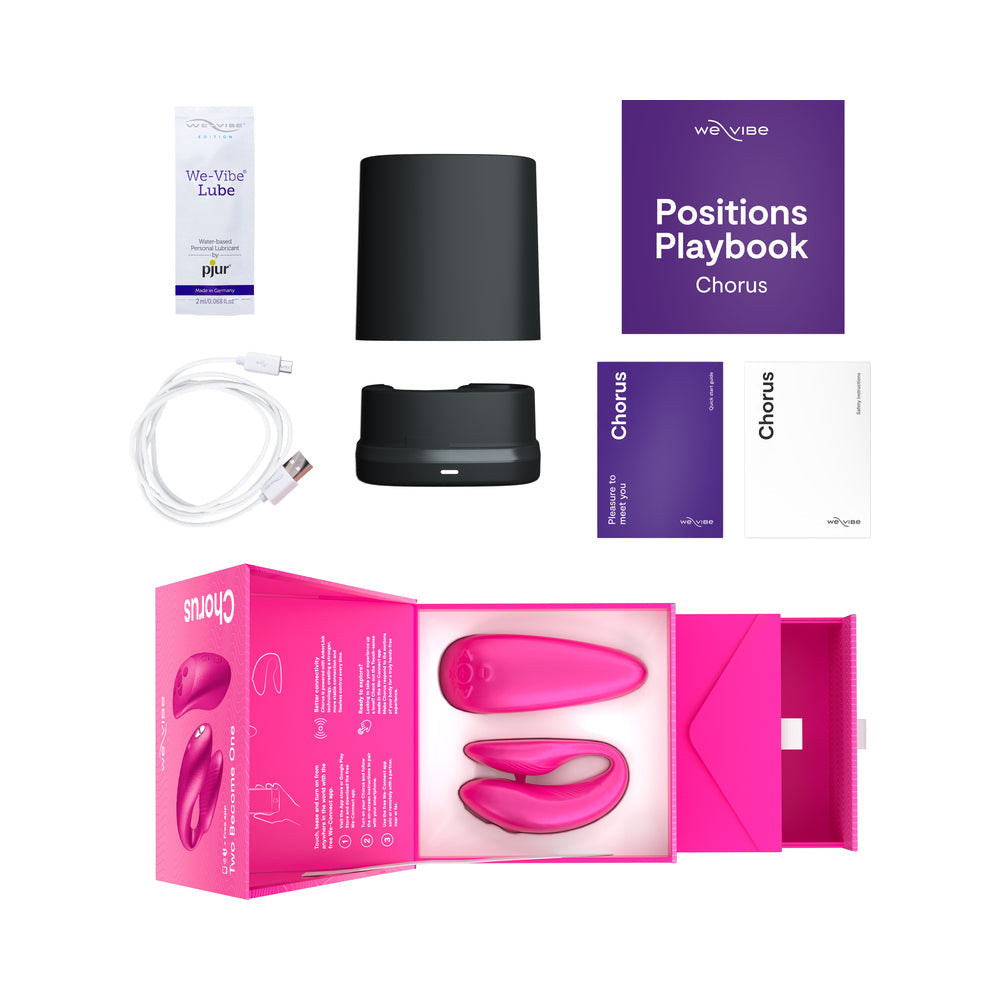 We-Vibe Chorus Couples Vibrator Cosmic Pink with accessories including lube, positions playbook, and charging cable.