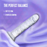 Naturally Yours Gala Sparkling Dildo Clear on a silky background highlighting its features.