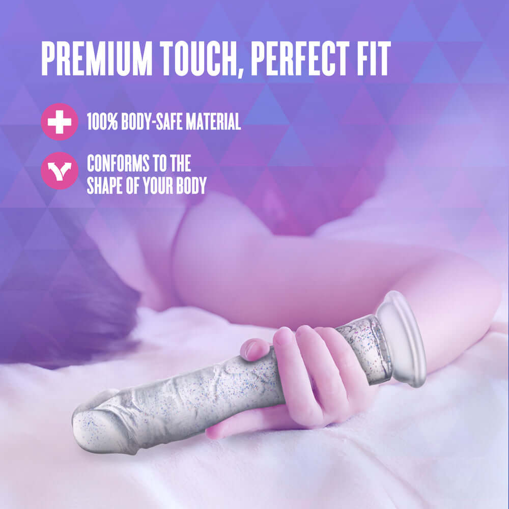 Naturally Yours Glamor Sparkling Dildo Clear on a soft surface highlighting premium touch and body-safe material.