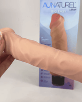Au Naturel 8.75 inch Vibrating Dildo Vanilla Ice Beige displayed next to its packaging, showcasing its realistic design.