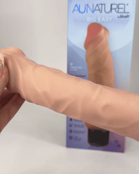 Au Naturel 8.75 inch Vibrating Dildo Vanilla Ice Beige displayed next to its packaging, showcasing its realistic design.
