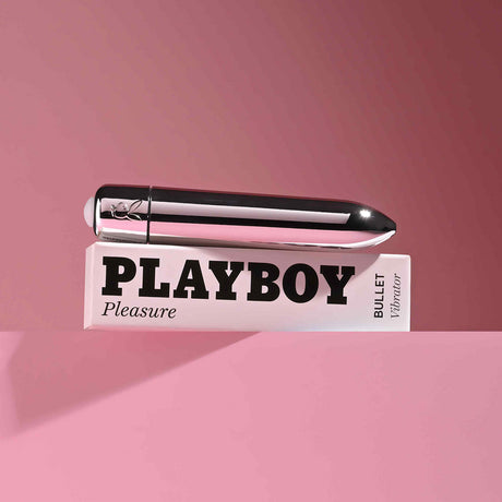 Playboy Pleasures 70th Anniversary Bullet on a pink background, showcasing its sleek design and powerful performance.