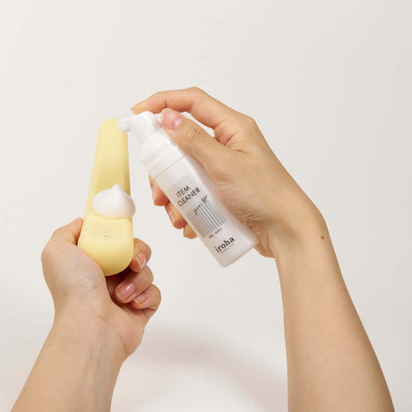 A person using Tenga iroha Item Cleaner on an intimate product for hygienic cleaning.