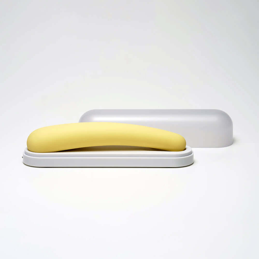 iroha tsuki MIKAZUKI Massager in a sleek white case, showcasing its elegant yellow design and ergonomic shape.
