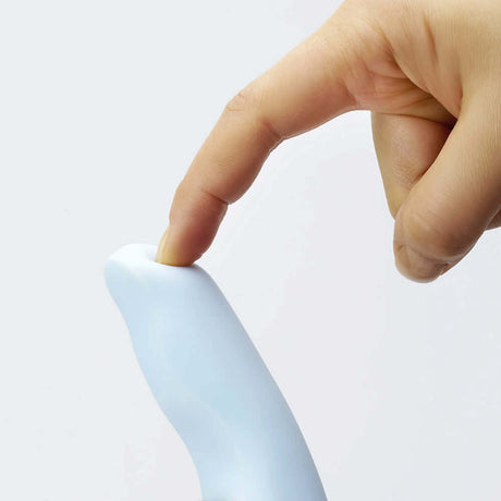 Close-up of a finger pressing the top of the iroha tsuki MINAMO Massager's curved design for a comfortable experience.