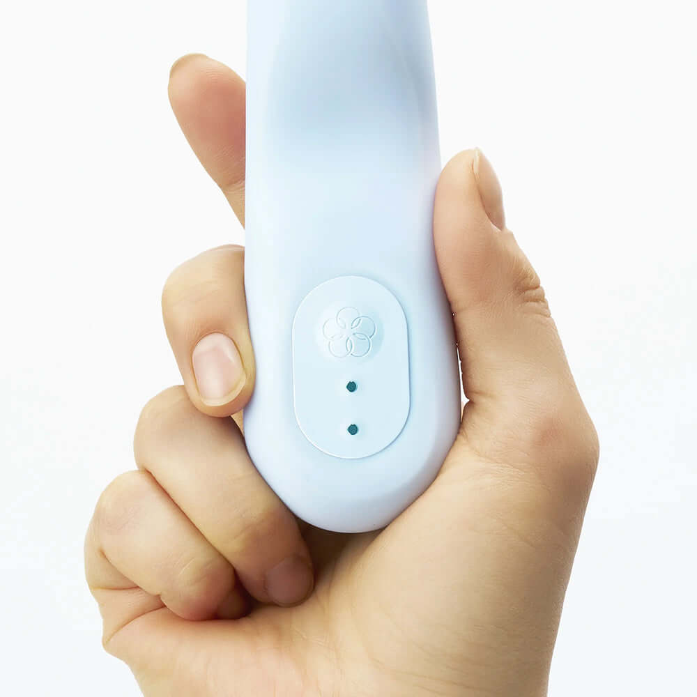 Hand holding the iroha tsuki MINAMO Massager, showcasing its soft curves and user-friendly controls for intimate pleasure.