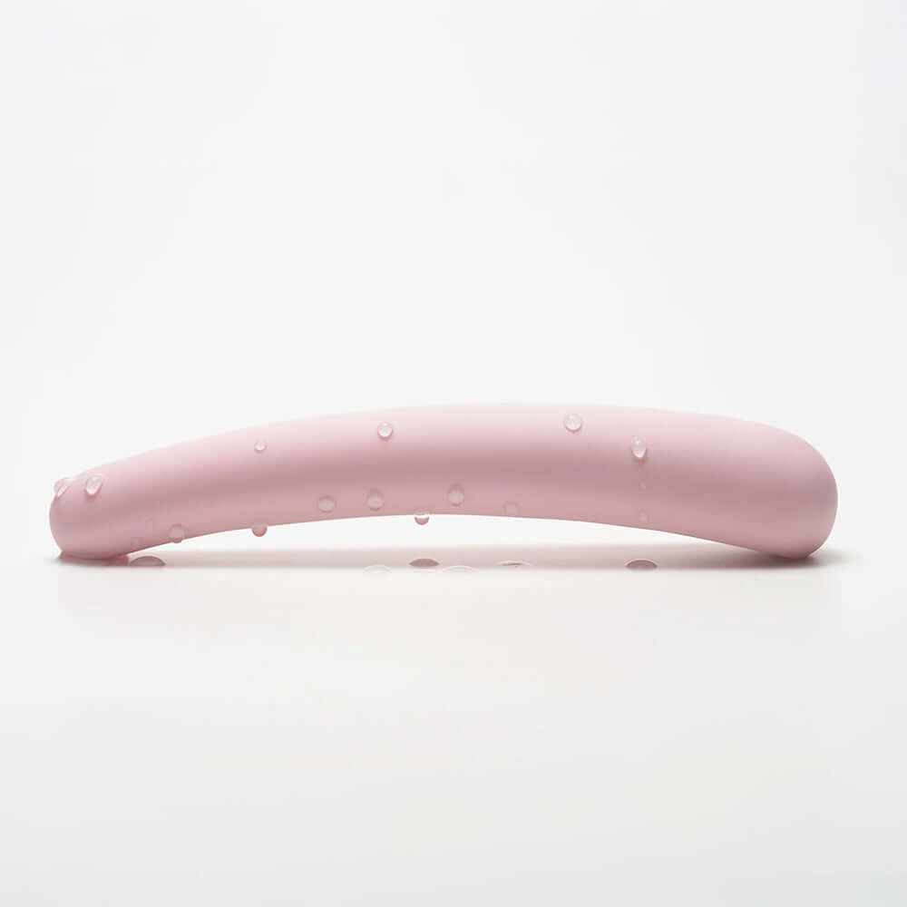 iroha tsuki MIKAZUKI NADESHIKO Massager shown with water droplets on a soft pink surface.