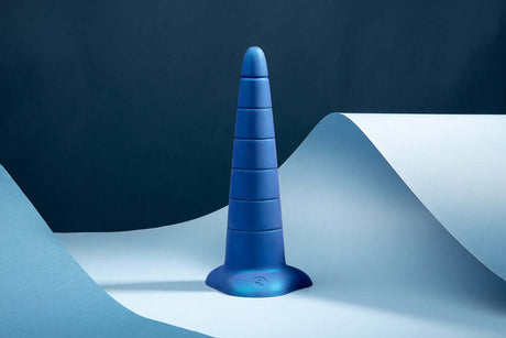 b-Vibe Anal Stretcher Training Cone displayed against a blue background for anal training and gradual expansion.