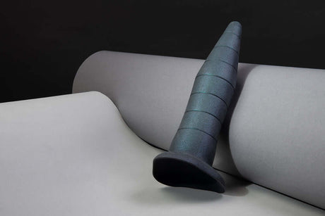 b-Vibe Fisting Anal Trainer on smooth grey background, showcasing its tapered and graduated design.