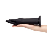 b-Vibe Vibrating Silicone Fisting Dildo held in hand showcasing its sleek design and size.