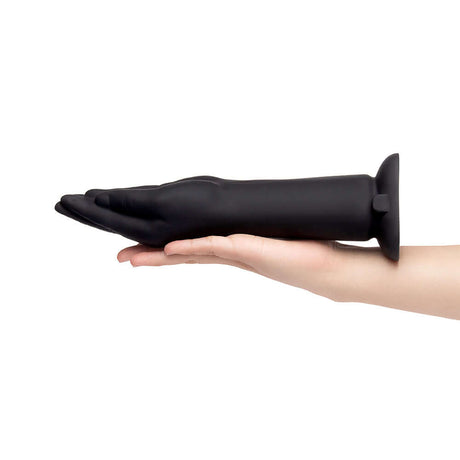 b-Vibe Vibrating Silicone Fisting Dildo held in hand showcasing its sleek design and size.