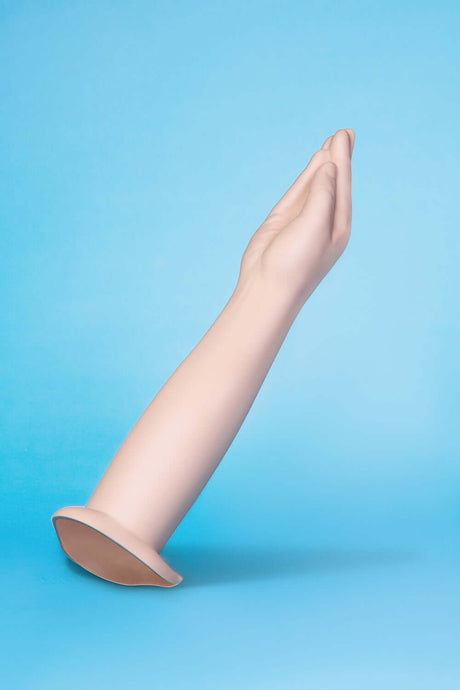 b-Vibe Silicone Hand Fisting Dildo showcasing a lifelike hand design on a blue background.