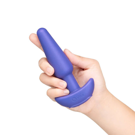 b-Vibe Butties Shake Vibrating Butt Plug held in hand, showcasing its sleek design and premium silicone material.