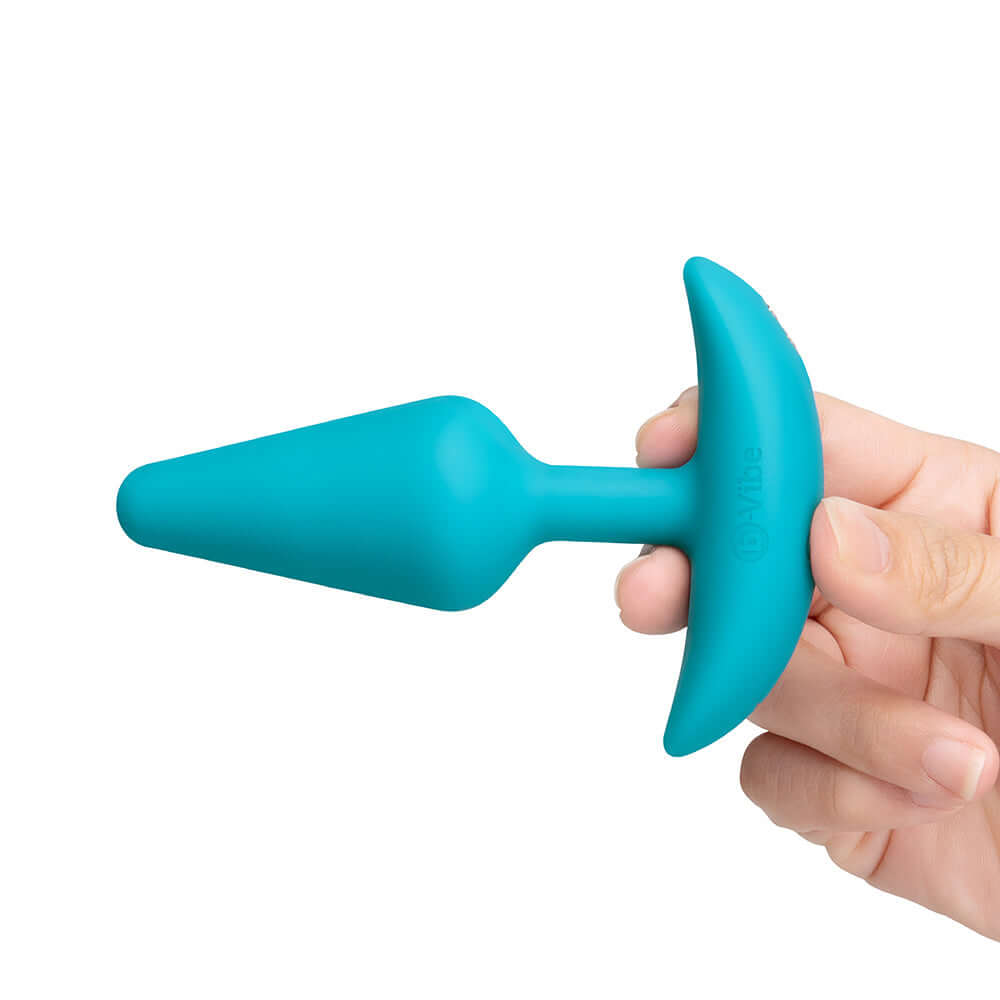 b-Vibe Butties Anal Training 2-Piece Set smaller tapered silicone plug held in hand for beginners.