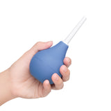 b-Vibe Compact Enema Douche Blue in hand, highlighting its ergonomic design and travel-friendly size.