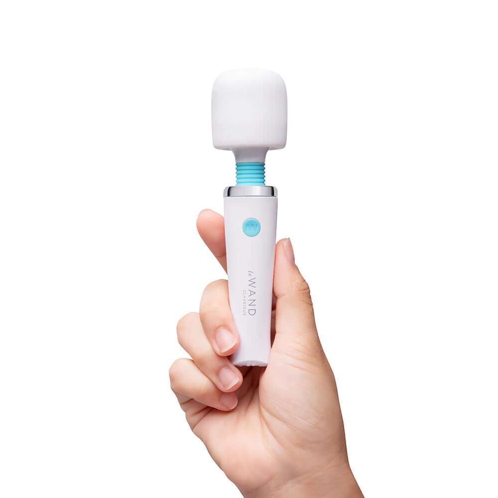 Le Wand Classique Mini Wand Massager held in hand, showcasing its compact design and premium features.