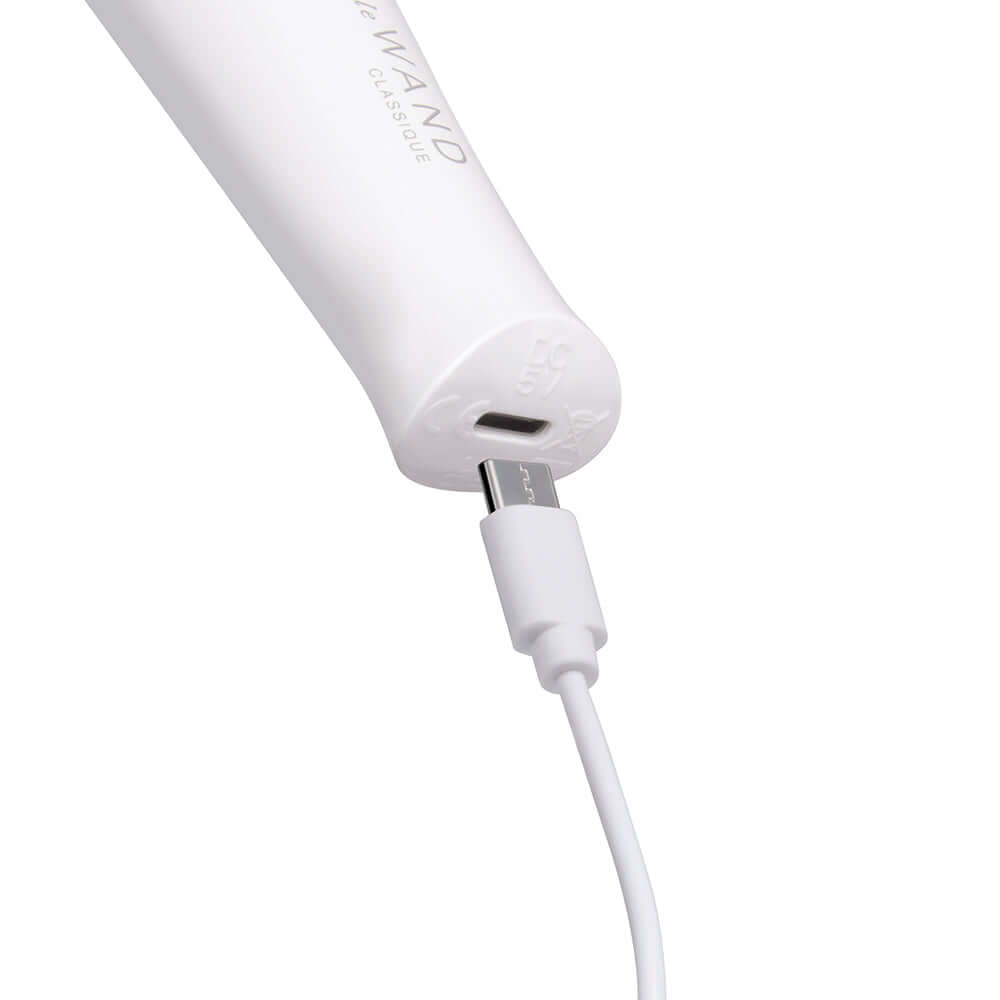 Close-up of Le Wand Classique Mini Wand Massager charging with USB cable.