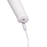 Le Wand Classique Petite Wand Massager charging port with USB cable connected for recharging.