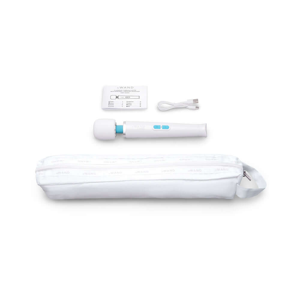 Le Wand Classique Petite Wand Massager, USB cable, instruction card, and pouch displayed on a white background.