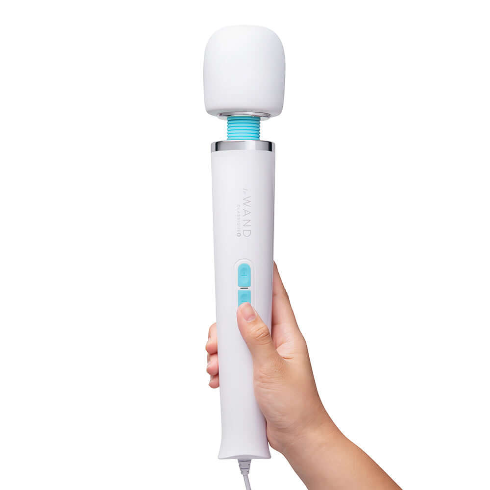 Le Wand Classique Plug-In Wand Massager held in hand, showcasing its sleek design and powerful functionality.