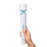 Le Wand Classique Rechargeable Wand Massager held in hand, showcasing sleek design and easy control button.