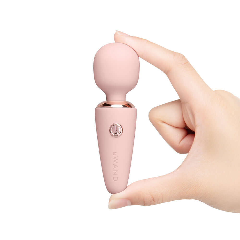 Le Wand Mini Micro Wand Rose Gold held in hand, showcasing compact design and elegant silhouette.