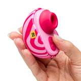 ROMP Spin Travel Rechargeable Clitoral Stimulator in hand, showcasing its vibrant design and controls.