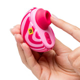 ROMP Spin Travel Rechargeable Clitoral Stimulator held in hand, featuring suction tip and control buttons.