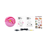 Image of the ROMP Spin Travel Rechargeable Clitoral Stimulator, USB cable, instruction booklet, and stickers.