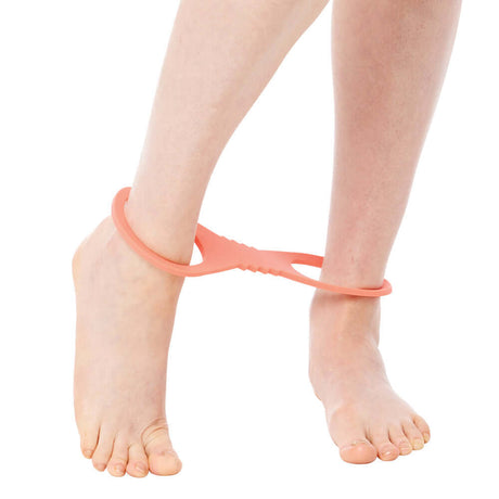 Person wearing Sportsheets Sex & Mischief Peaches n CreaMe Large Silicone Cuffs on ankles for playful restraint.