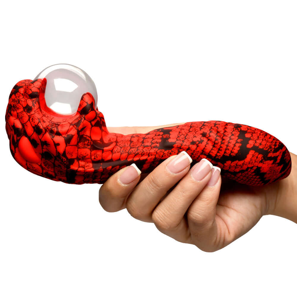 Creature Cocks Cobra Scepter Plasma Vibrator held in hand with striking red and black cobra-like design.