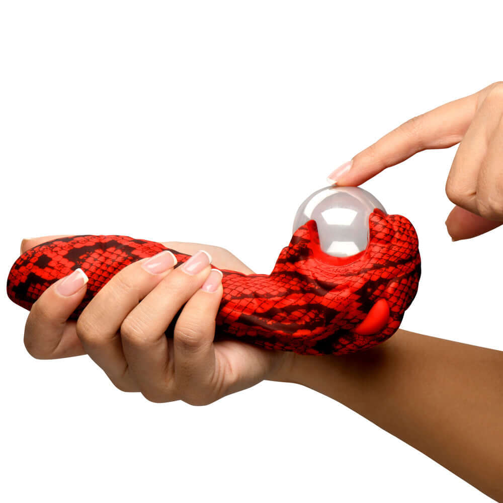 Hand holding the Creature Cocks Cobra Scepter Plasma Vibrator with a shiny clear end.