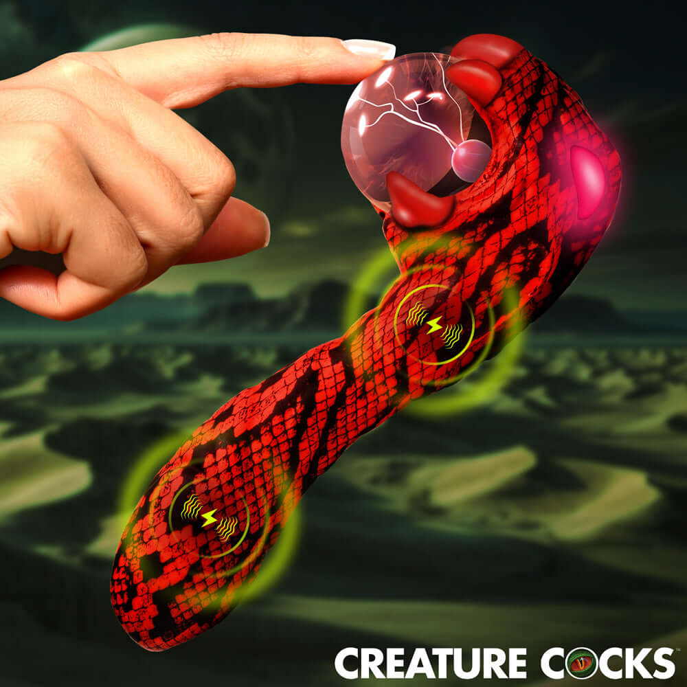 Hand reaching out to touch the Creature Cocks Cobra Scepter Plasma Vibrator with vibrant colors and design.