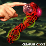 Hand reaching out to touch the Creature Cocks Cobra Scepter Plasma Vibrator with vibrant colors and design.