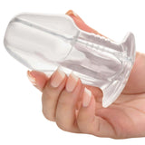 Master Series Dicked Clear Hollow Anal Plug Medium held in hand, showcasing its transparent design for versatile pleasure.