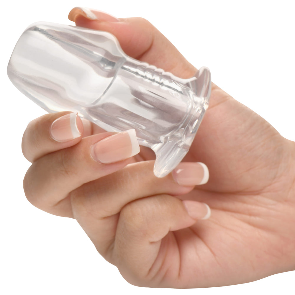 Hand holding the Master Series Dicked Clear Hollow Anal Plug Small, showcasing its transparent design.