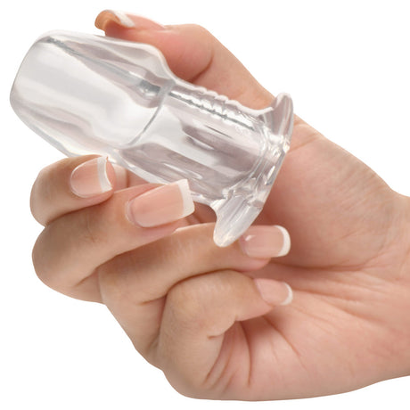 Hand holding the Master Series Dicked Clear Hollow Anal Plug Small, showcasing its transparent design.